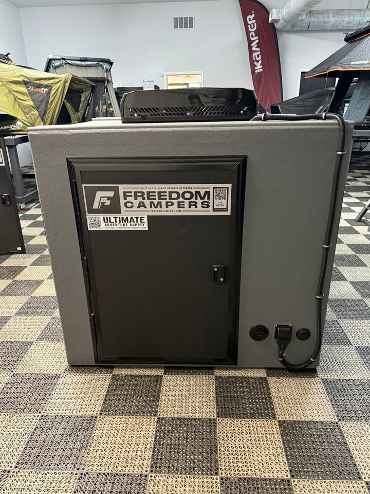Pre-Owned Freedom Camper 58x89 Gray - rear door with shore power port and rooftop OutEquip air conditioner
