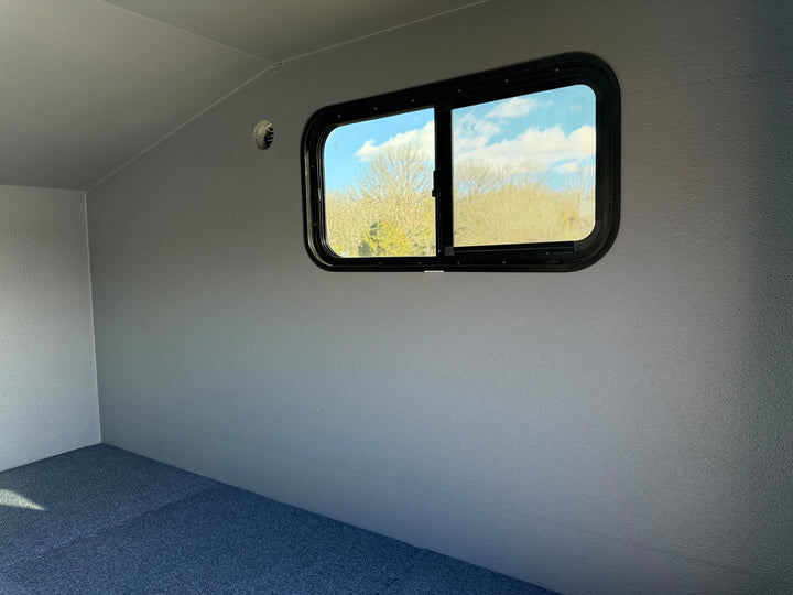 Freedom Camper 58x89 Ultimate Package Gray - interior window wall and carpeted floor