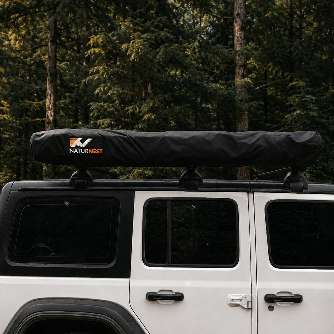 Naturnest 270 Plus X-TEND Awning in its protective travel cover mounted on a vehicle