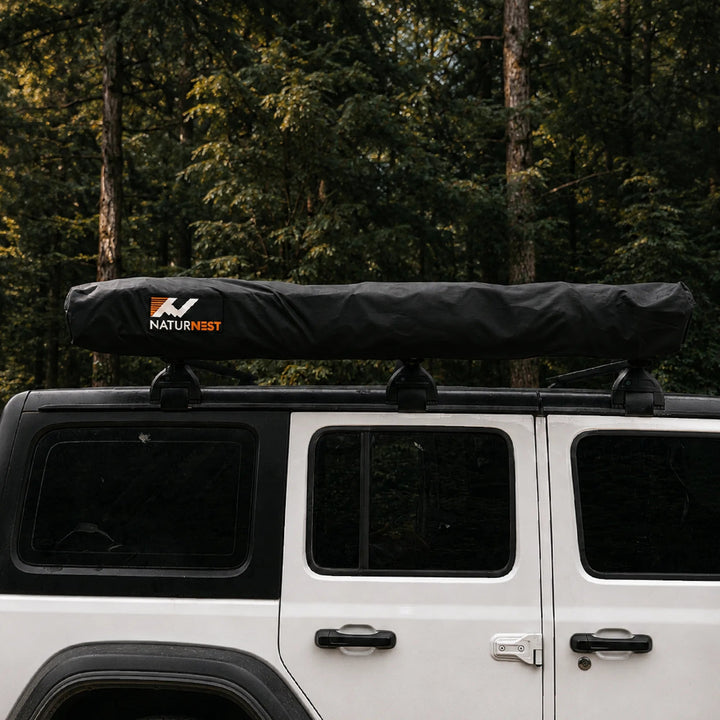 Naturnest 270 Plus X-TEND Awning in its protective travel cover mounted on a vehicle