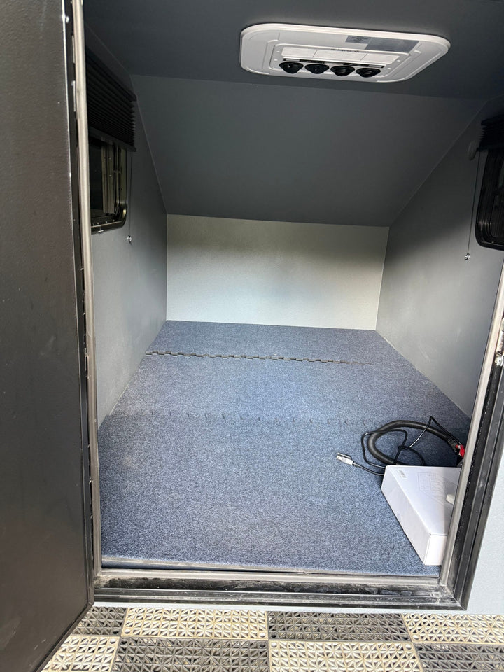 Pre-Owned Freedom Camper 58x89 Gray - interior with carpeted floor and OutEquip ceiling air distribution vents
