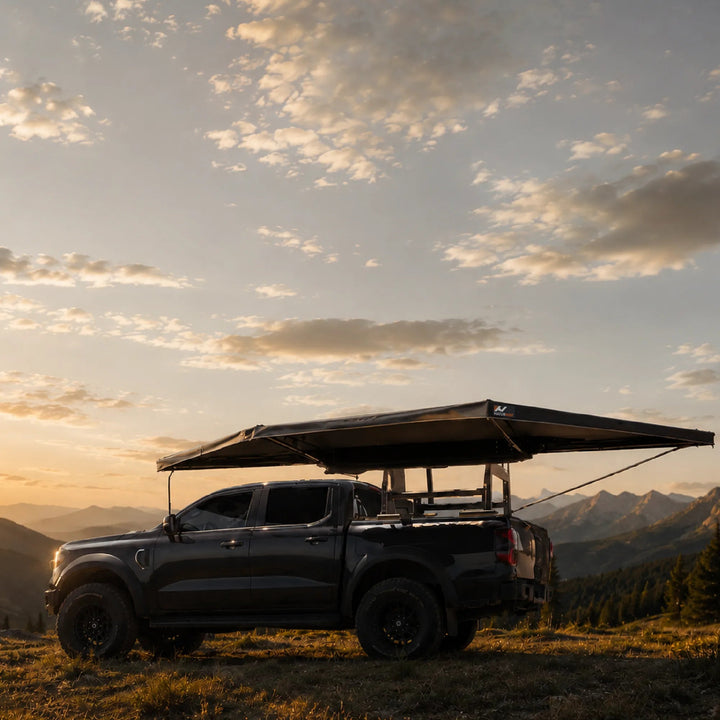 Naturnest 180 Awning side view deployed over a truck at sunset