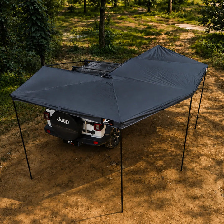 Naturnest 270 Plus X-TEND Awning deployed behind a Jeep, overhead angle