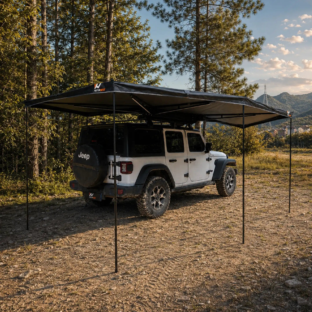 Naturnest 270 Plus X-TEND Awning deployed over a Jeep at a forest campsite