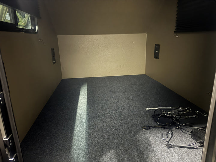 Pre-Owned Freedom Camper 58x79 Tan - carpeted interior floor and tie-down points