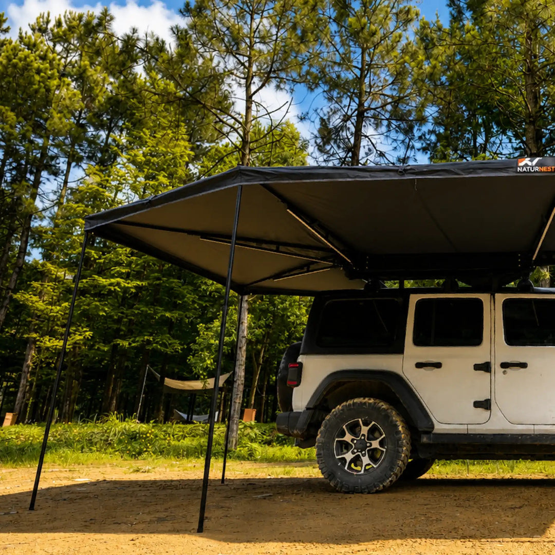 Naturnest 270 Plus X-TEND Awning deployed over a Jeep, side view